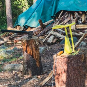 There is a blue tarp on top of a tree stump