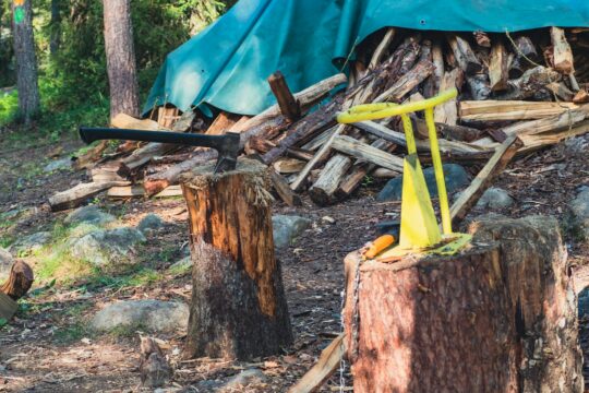 There is a blue tarp on top of a tree stump